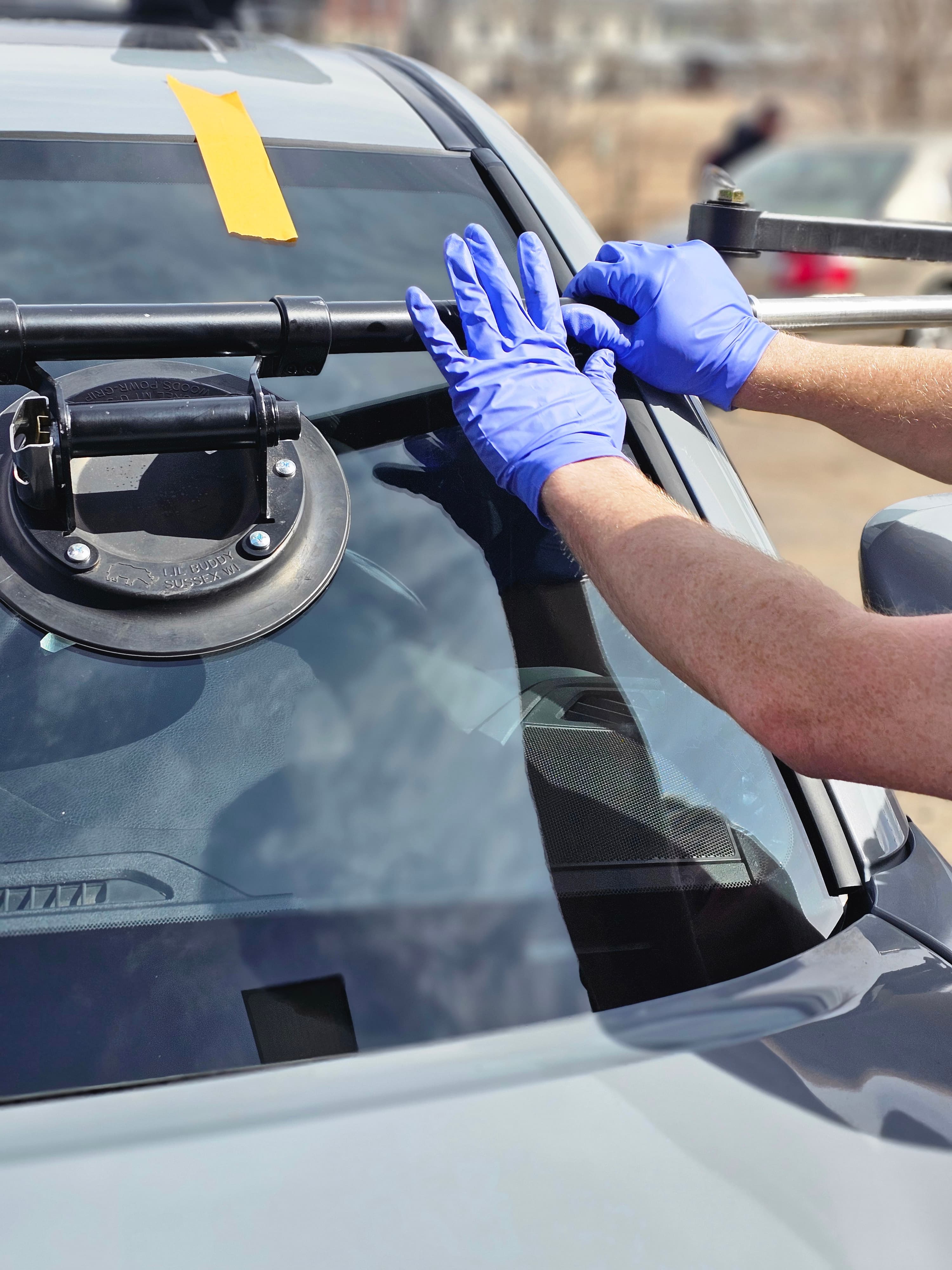 Polaris AutoGlass technician carefully placing windshield